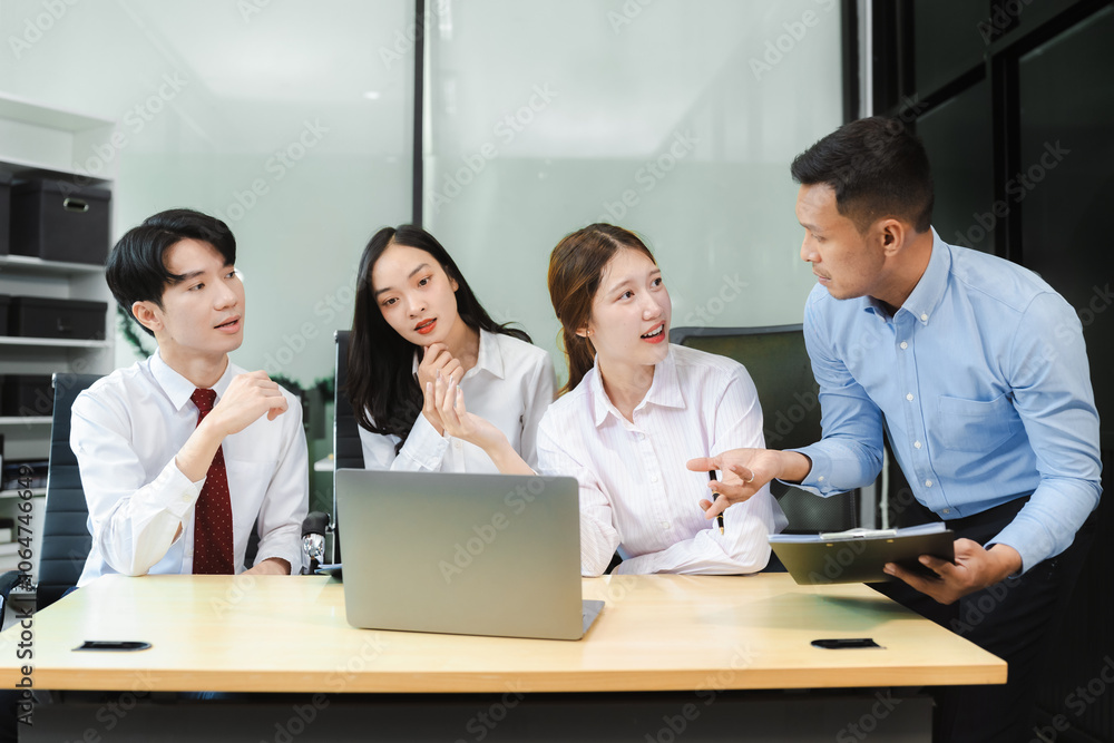 Business team working on a project in the office or reviewing and discussing a business project. Business team working on a project in the office or reviewing and discussing a business project.