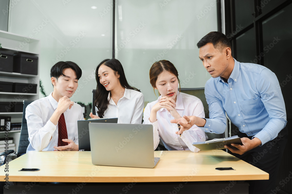 Business team working on a project in the office or reviewing and discussing a business project. Business team working on a project in the office or reviewing and discussing a business project.