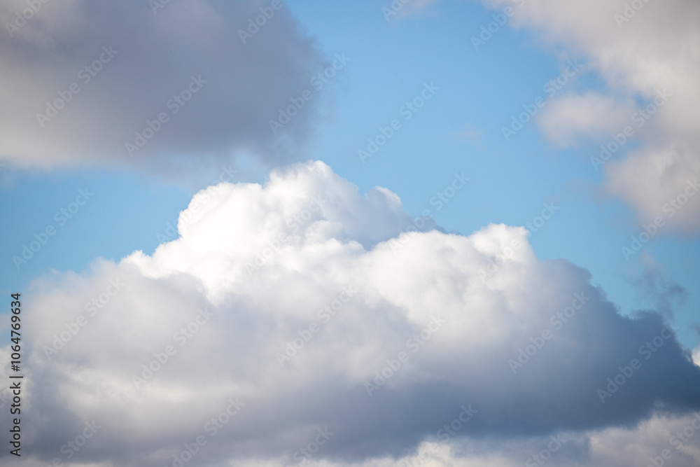 A large cloud in the sky with a blue sky behind it A large cloud in the sky with a blue sky behind it