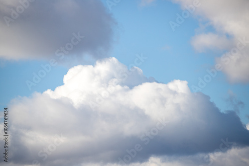 A large cloud in the sky with a blue sky behind it