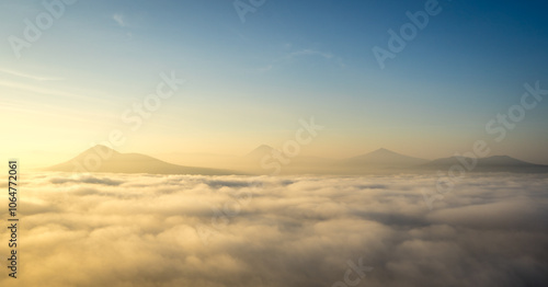 Hills in foggy evening. Radobyl hill in Czech Midland/ Ceske Stredohori, Czech republic