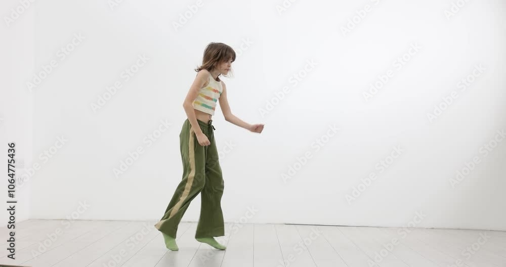 Girl recording a dance moves in front of camera on white background Girl recording a dance moves in front of camera on white background