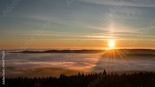 Sunset in the Teplice-Adršpašské rocks. The sun is low on the horizon and the inverted clouds create stunning scenery that makes it seem as if you are above the clouds.