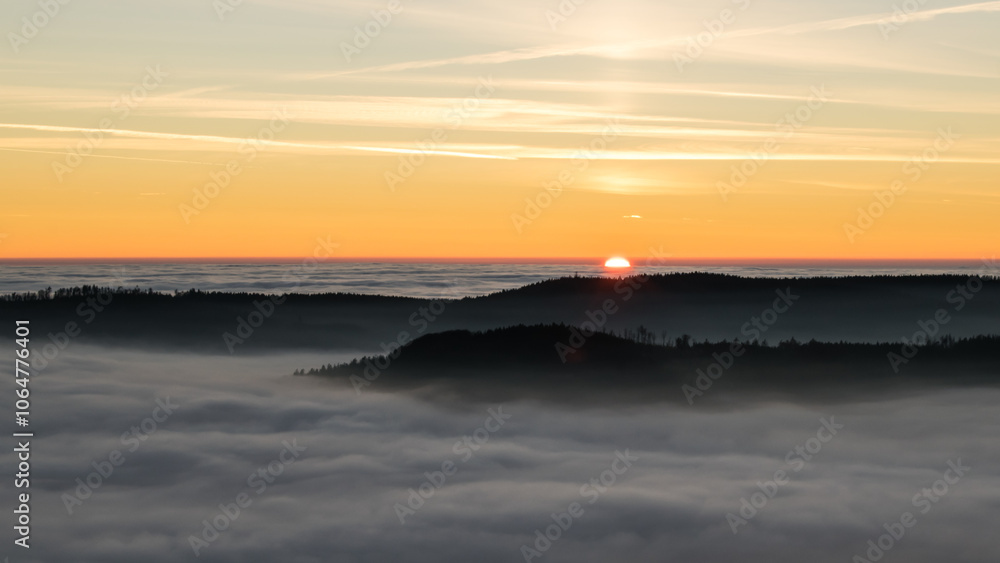 Fototapeta premium Sunset in the Teplice-Adršpašské rocks. The sun is low on the horizon and the inverted clouds create stunning scenery that makes it seem as if you are above the clouds.
