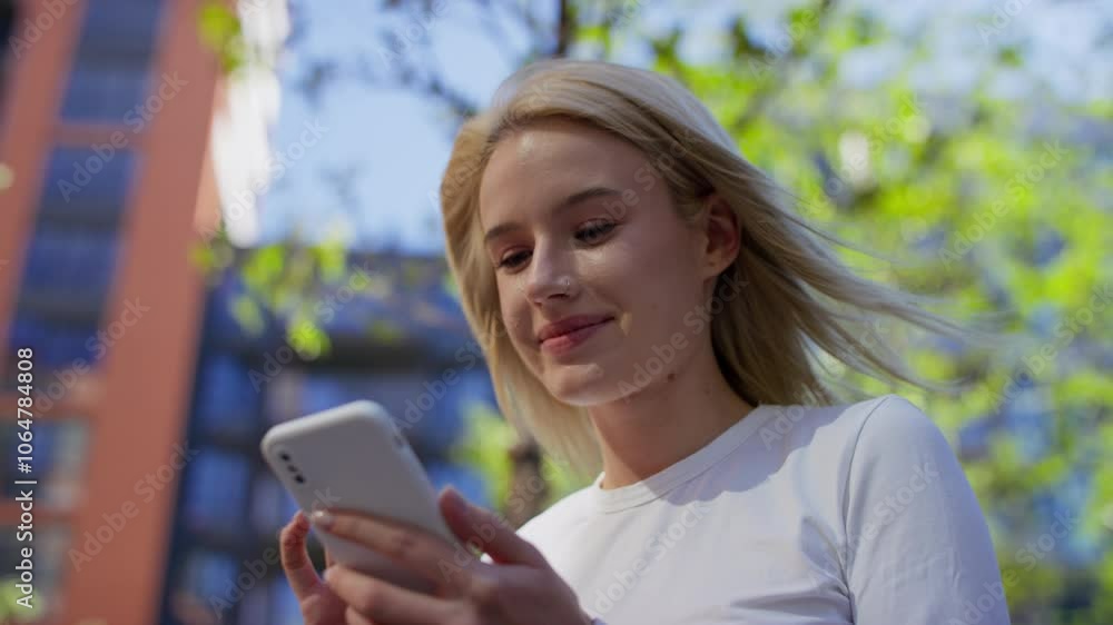 Excited Woman Reacting to News on Smartphone Outdoors Excited Woman Reacting to News on Smartphone Outdoors
