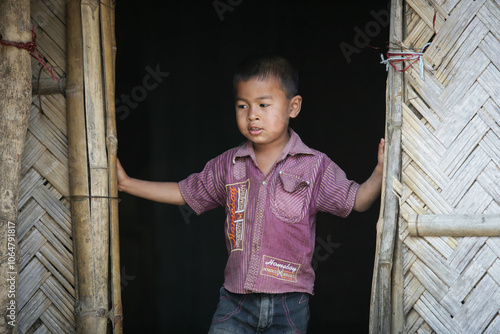 Bangladeshi tribal kid standing in doorway  photo