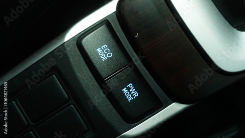 Eco mode and power mode buttons on a Japanese car manufacturer.