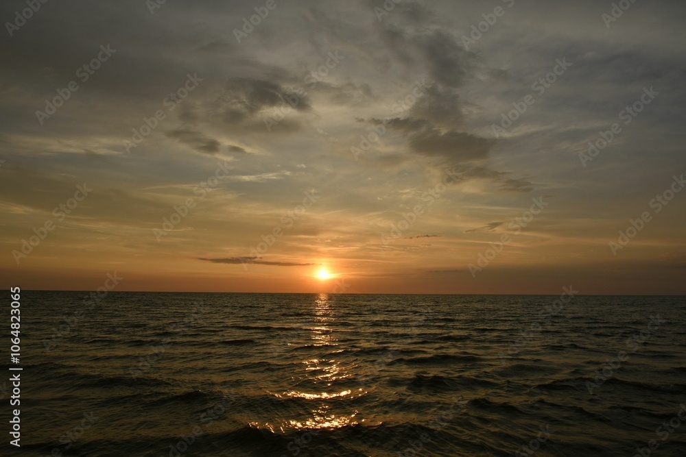 Serene ocean sunset with golden hues. Serene ocean sunset with golden hues.