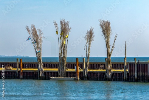 Obraz na płótnie The pricks or bars mark a narrow and flat fairway. Pricken or poles are used as permanent navigation marks where buoyancy would be too expensive or not possible because the water depth is too shallow w salonie