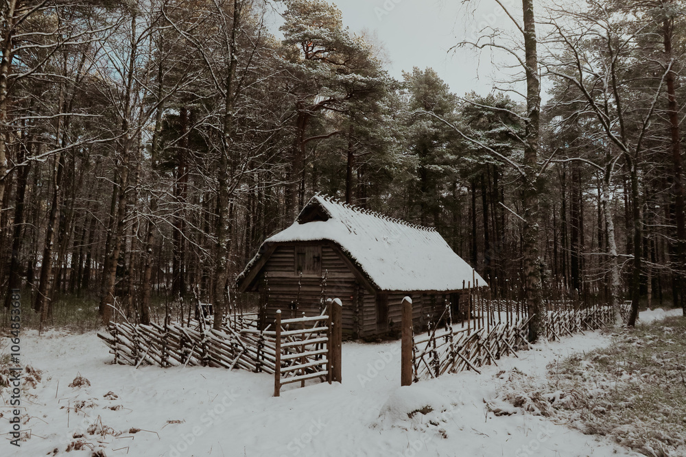 Snowy wooden cabin in a tranquil forest setting of Estonia during winter season Snowy wooden cabin in a tranquil forest setting of Estonia during winter season