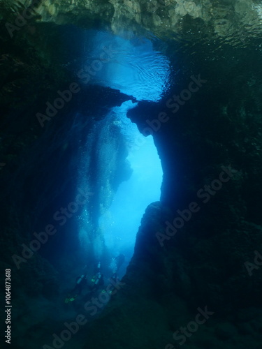 cave diving underwater scuba divers exploring reefs and caves