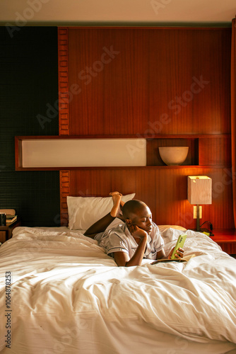 A young black woman with a shaved head waking up on on a sunny summer morning in a lovely cozy room