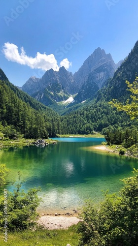 Serene mountain lake surrounded by lush greenery and towering peaks during a sunny day in a remote alpine region