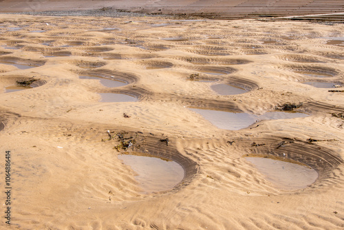 Nature Made Pits In The Sand On The Beach Creating Small Pools Of Water