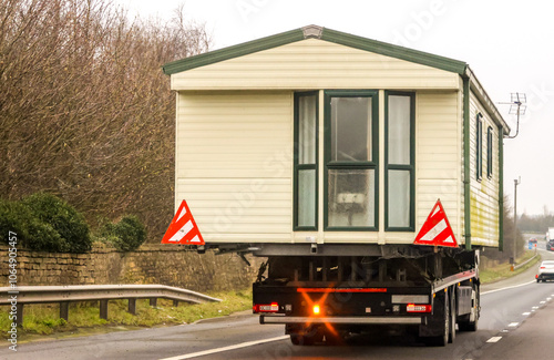 A Lorry Carrying A Static Caravan Home To It's Next Location And New Customer