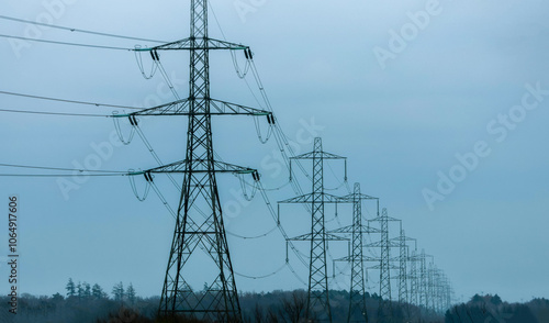 Electricity Pylons Tower Above And Stretch Across The Landscape Of The United Kingdom