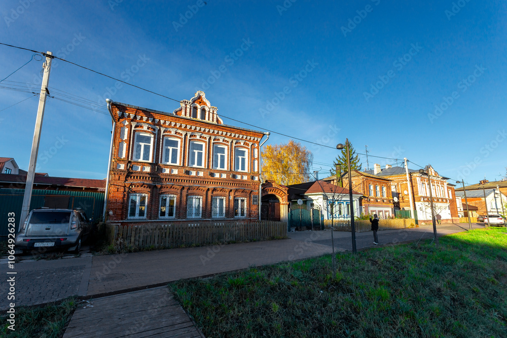 Naklejka premium Bogorodsk, Nizhny Novgorod region, Russia, Street view of an ancient provincial Russian city on the shore of a lake on a summer evening. An ancient building of artisans, an architectural monument.