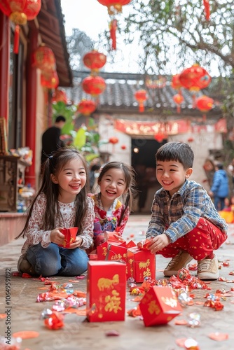 Group of children playing with Chinese New Year lanterns in a decorated courtyard, with red envelopes, banners, and joyful expressions photo