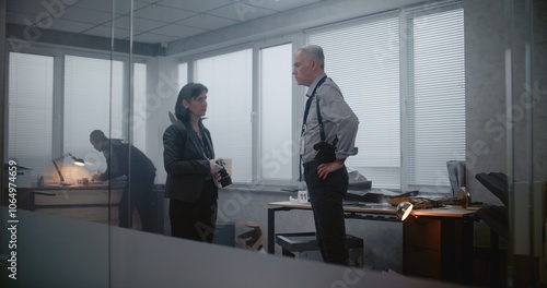 Wallpaper Mural Office robbery or murder case: Investigation team at crime scene. Female forensic scientist takes photos of evidence, then talks to male detective. African American policeman looks for fingerprints. Torontodigital.ca