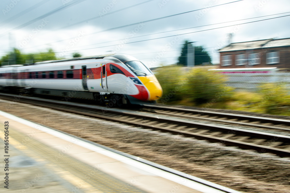 A Passing High Speed Passenger Train Flying Past A Train Station Platform A Passing High Speed Passenger Train Flying Past A Train Station Platform