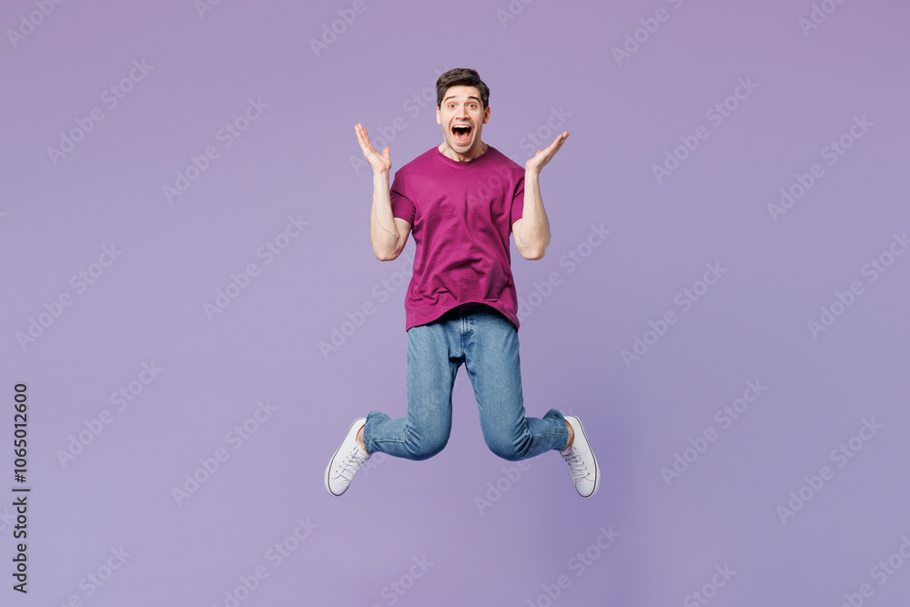 Full body young shocked surprised happy man he wear violet t-shirt casual clothes jump high look camera spread hands isolated on plain pastel light purple background studio portrait Lifestyle concept Full body young shocked surprised happy man he wear violet t-shirt casual clothes jump high look camera spread hands isolated on plain pastel light purple background studio portrait Lifestyle concept