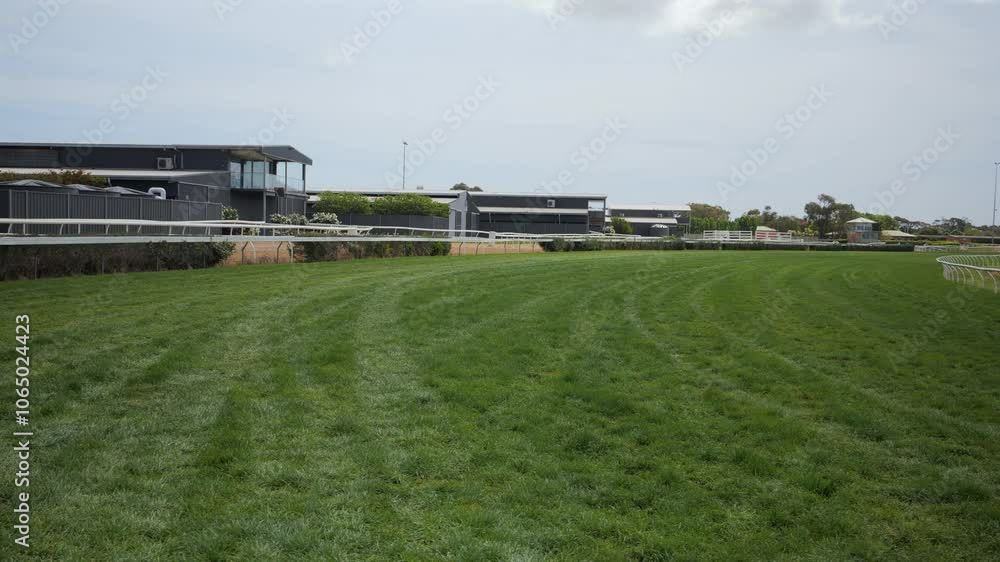 Pan over horse race track with green grass Pan over horse race track with green grass