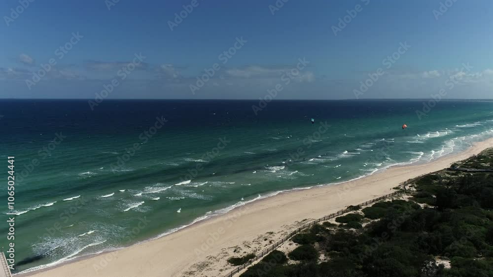 Drone shot over windy beach with kite surfers Drone shot over windy beach with kite surfers