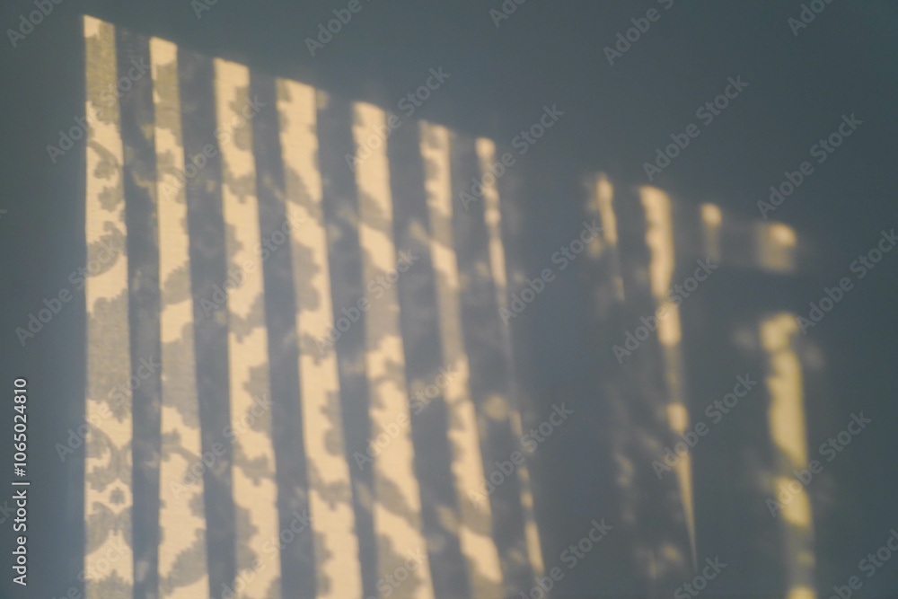 The shadow of the transparent curtains on a white wall. Mockup for design