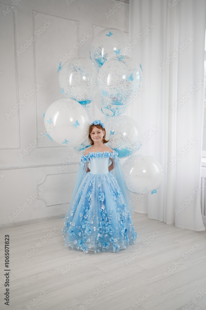 Fototapeta premium little girl in blue dress with giant helium balloons 