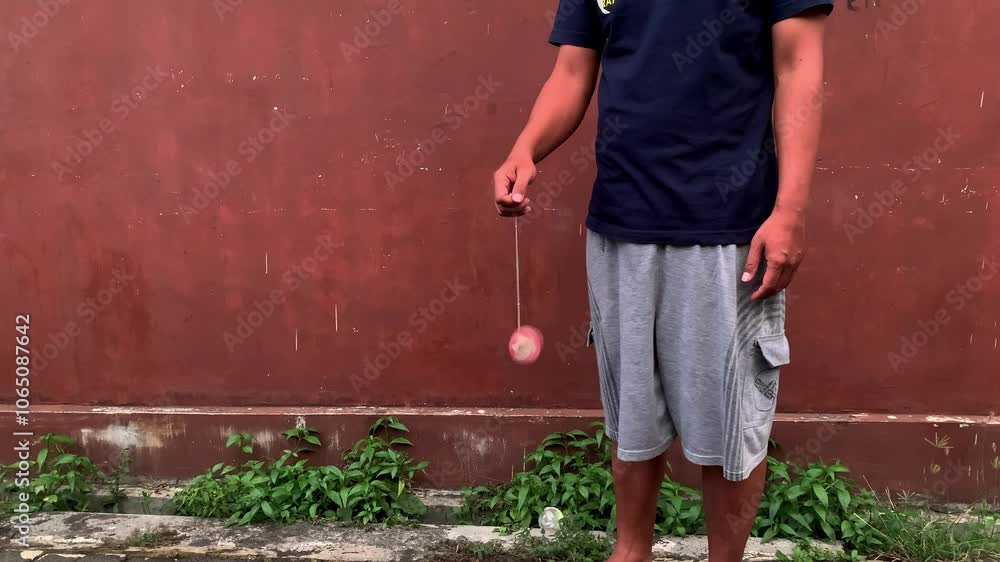 4K video of male hand playing yoyo. A yoyo is a toy consisting of two disks connected by an axle around which a string is wound. A yoyo is thrown down on a string and can be returned to the hand 4K video of male hand playing yoyo. A yoyo is a toy consisting of two disks connected by an axle around which a string is wound. A yoyo is thrown down on a string and can be returned to the hand