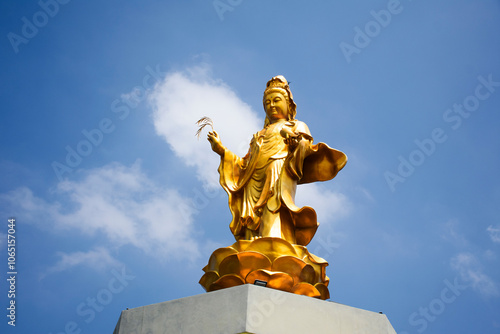 Ancient Golden Quan Yin angel deity or Kuan Yin gold chinese mercy goddess for thai people travel visit and respect praying wish holy mystery worship at Antique Chinese Shrine in Nonthaburi, Thailand photo