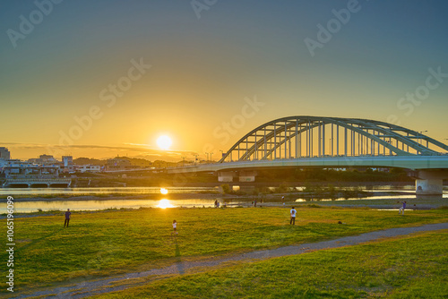 秋の夕方の東京都狛江市の多摩川河川敷から多摩水道橋と川崎市多摩区方面を見る photo