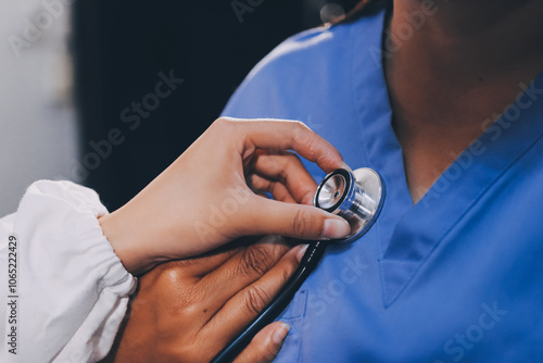 Female doctor use stethoscope to examine eldely paient heartbeat photo