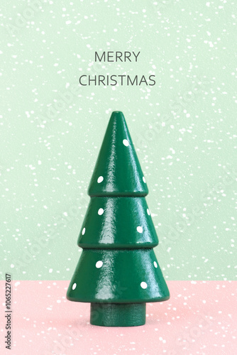 Christmas concept background. Green christmas tree with the text Merry Christmas on top and snowflakes