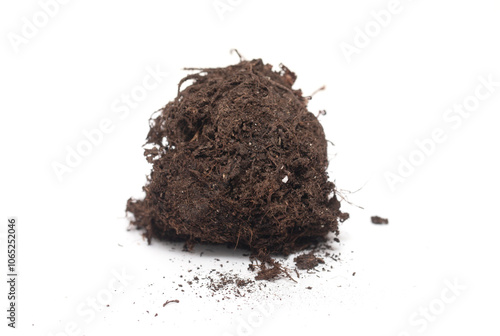 A pile of dirt with a few roots sticking out of it