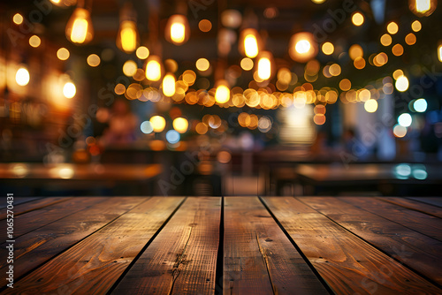 Empty wooden table top with a blurred background of a restaurant or bar interior, decorated with vintage hanging light bulbs and people having fun at night time.
