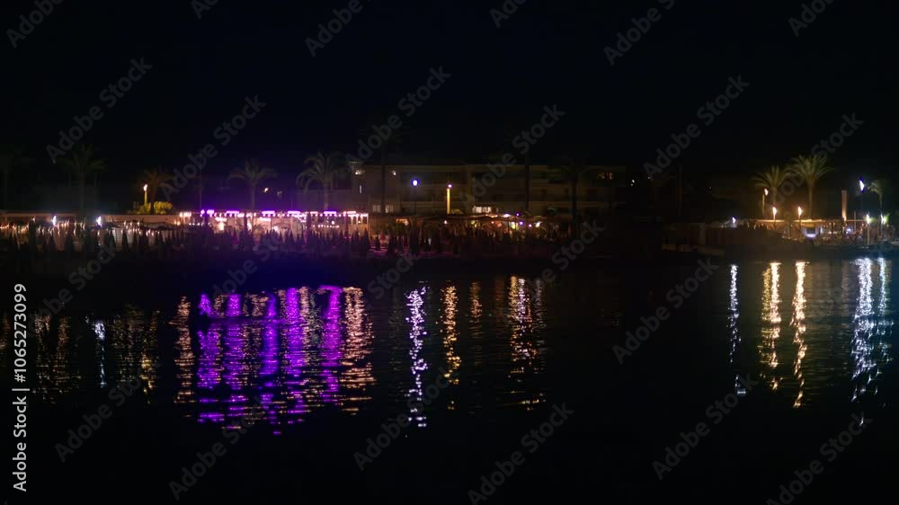 Lights reflecting in the sea at the beach at night Lights reflecting in the sea at the beach at night