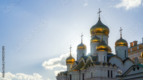 Golden domes of a Russian Orthodox church against a clear sky photo