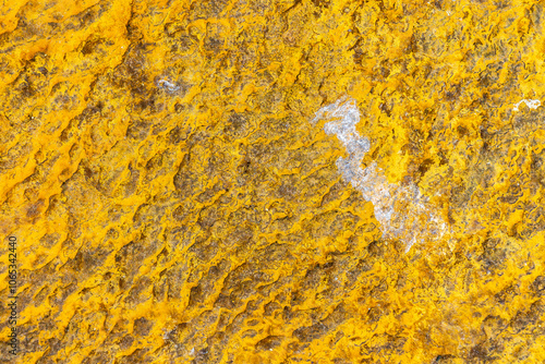 Vivid textures of natural sulfur deposits on rock surface photo