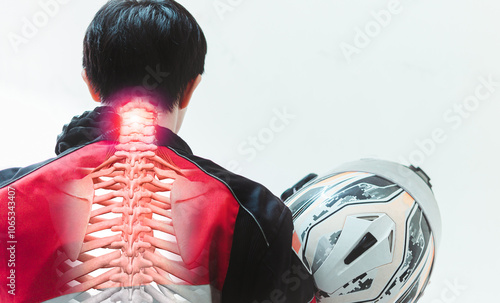 A motorcyclist stands, experiencing a twinge of cervical spine pain, clad in a futuristic ensemble and clutching a helmet, representing a fusion of technology and human anatomy photo