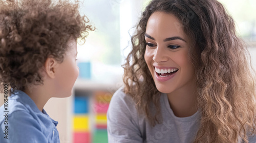 Speech Therapist Working One-on-One with a Child, Using Engaging Visual Aids and Playful Activities to Enhance Communication Skills in a Bright, Cheerful Setting photo