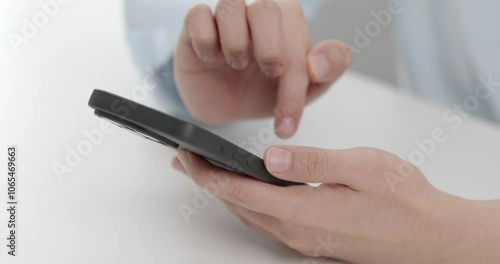 Close-up shot of a finger pressing the unlock button on a smartphone screen, capturing the precise moment of interaction and access to the device