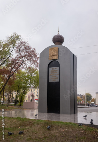 A tall gray building with a gold dome on top photo