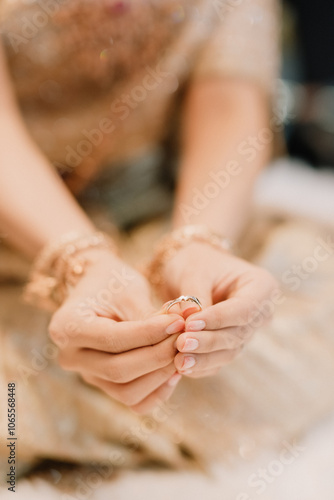 The bride and groom wear wedding rings.