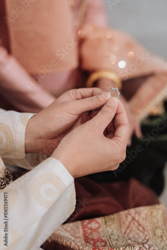 The bride and groom wear wedding rings.