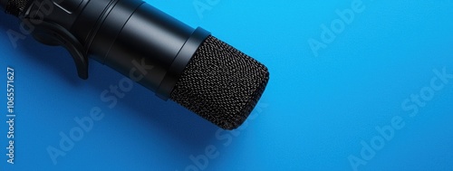 a microphone on a blue background, representing podcasting and YouTube recording equipment. Web banner with copy space on the right