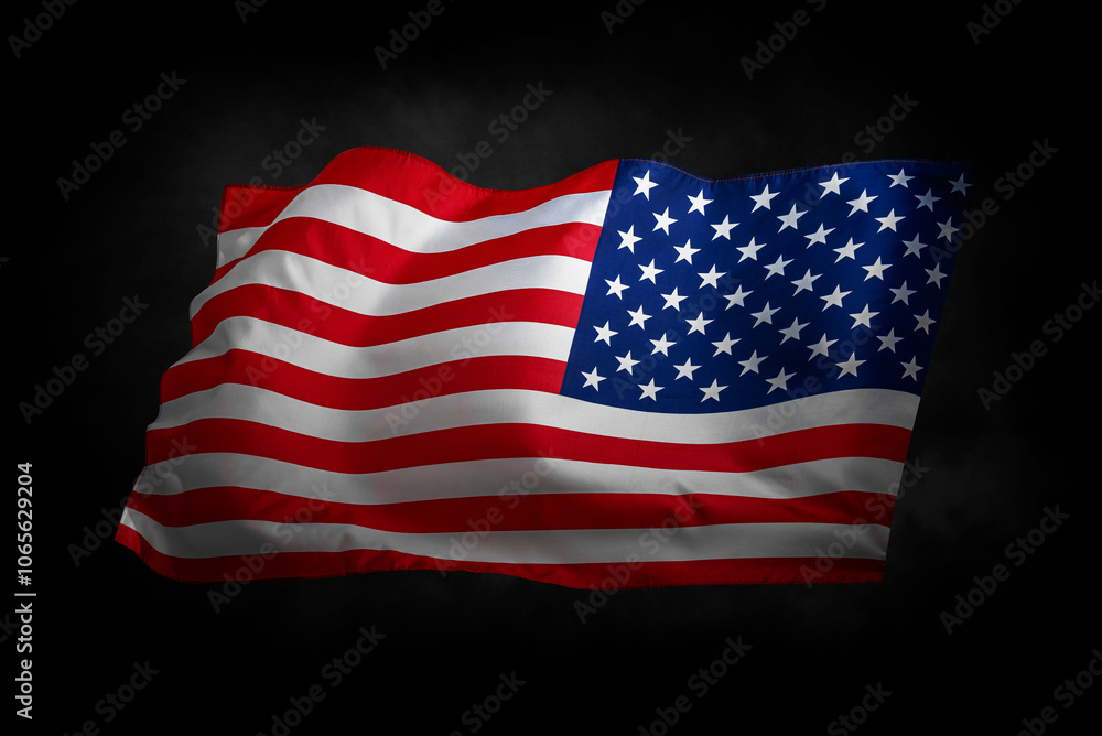 Flag of the United States of America. The US flag flutters in the wind. On a black background.