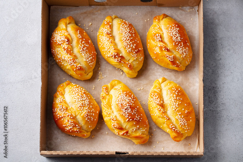 Sweet or savoury pies in a box. Grey background. Close up. Top view.