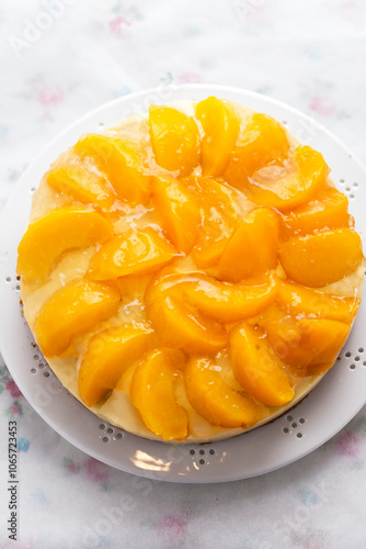 Cake with vanilla cream, peaches and white glaze 