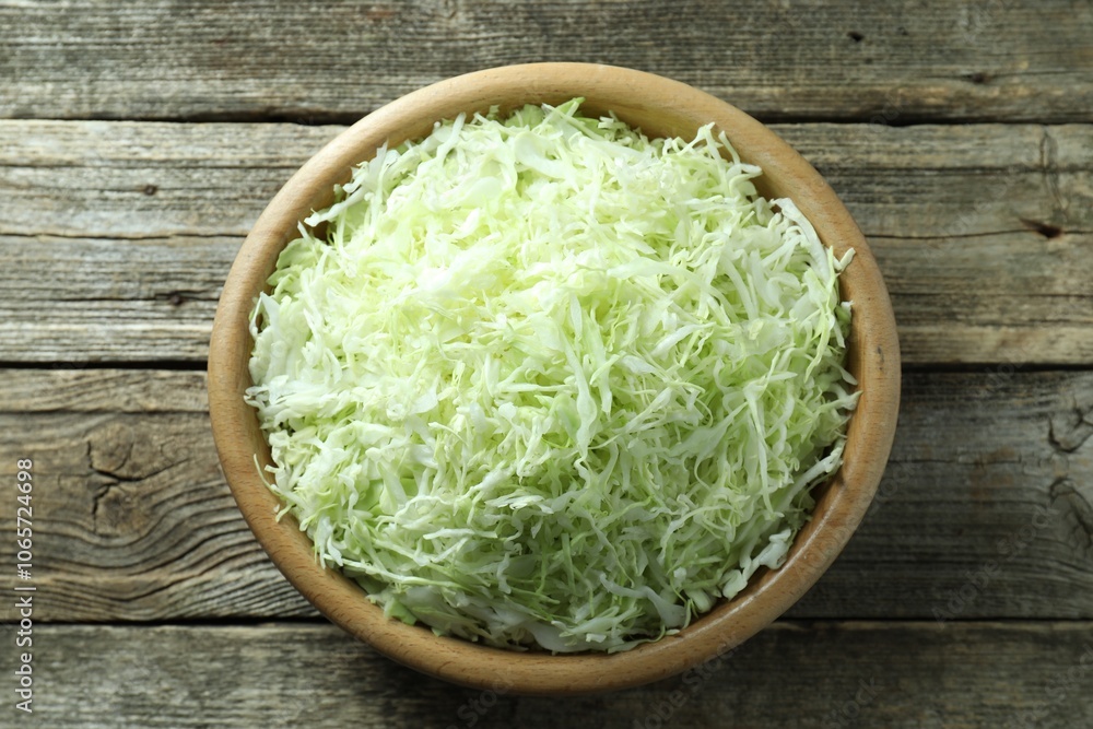 Fresh shredded cabbage on wooden table, top view Fresh shredded cabbage on wooden table, top view